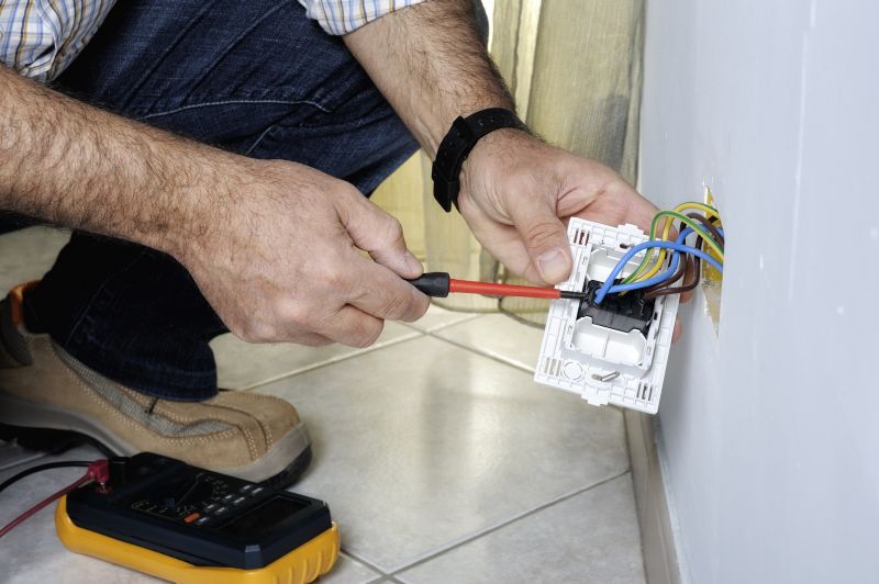 Electrician Repairing Outlet